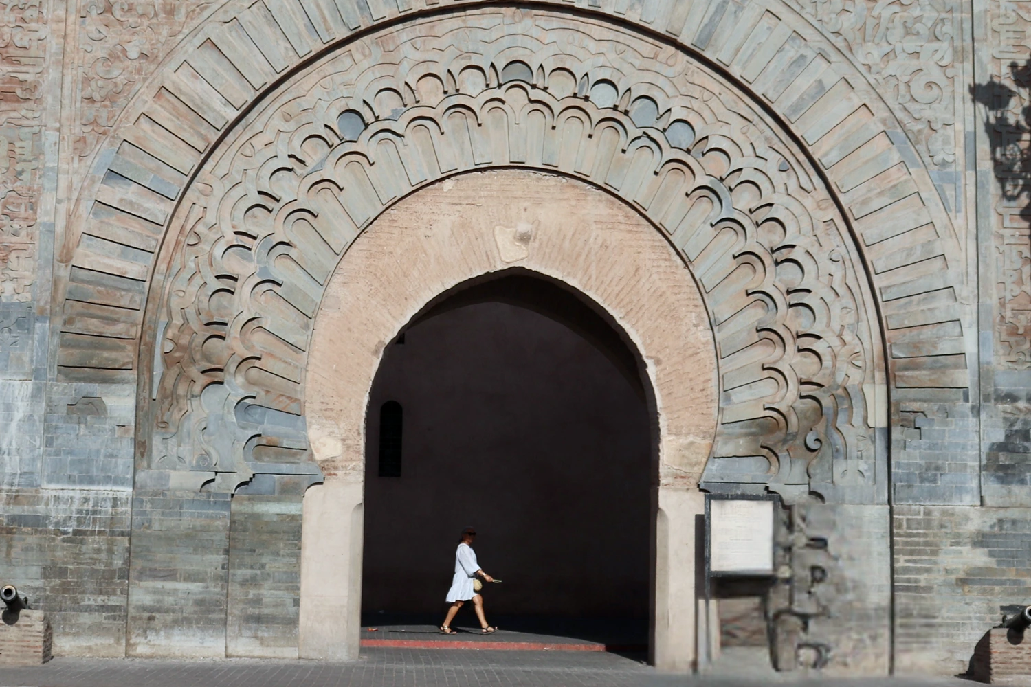 A person walking through Bab Agnaou the historic stone city gate of Marrakech